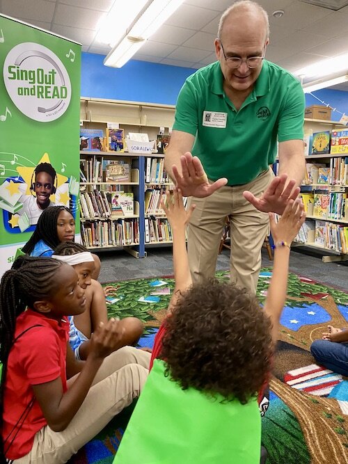 Carlo Franzblau high-fives a student at the recent celebration for the SOAR program.