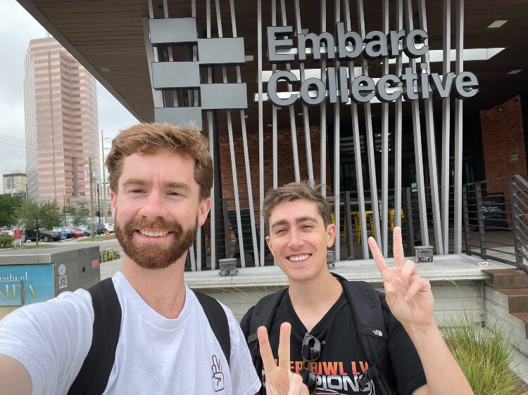 Twos co-founders Joe Steilberg and Parker Klein "throwing twos" in front of Embarc Collective, one of the organizations that has helped them on their entrepreneurial journey.