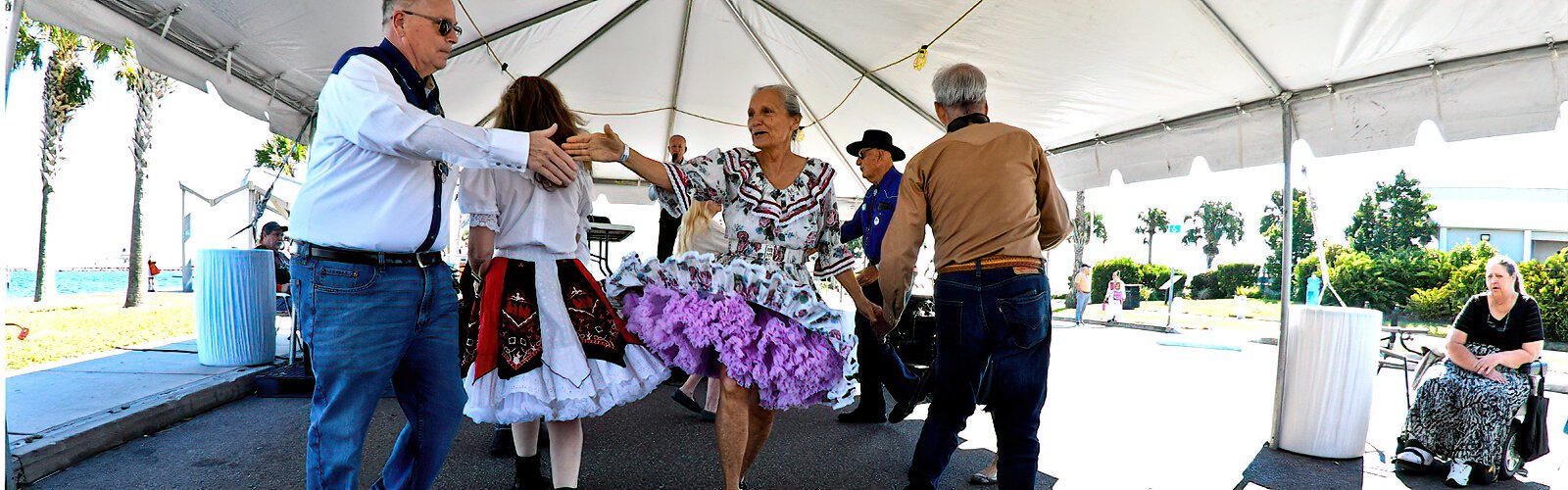 The dance club Promenade Squares participates in the International Folk Fair with their lively American square dances.