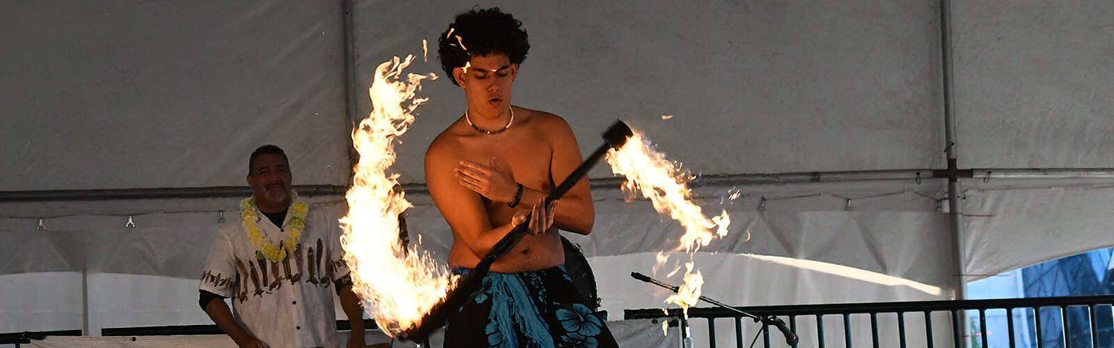 From Echo of the South Pacific, a young man displays his fire handling skills on stage.
