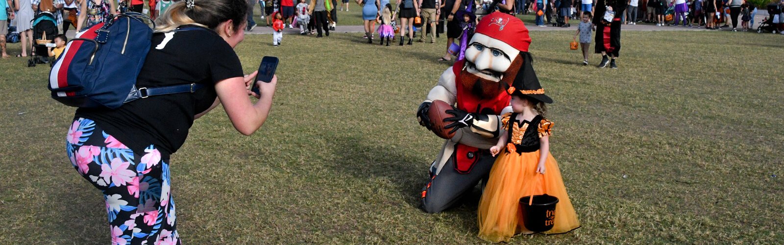  A caricatured Tampa Bay Buccaneer mascot serves as a prop for a Halloween portrait.