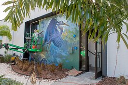 Artist Ernesto Maranje paints a mural on the offcies of the Florida Wildlife Foundation Corridor at The Factory, St. Pete.