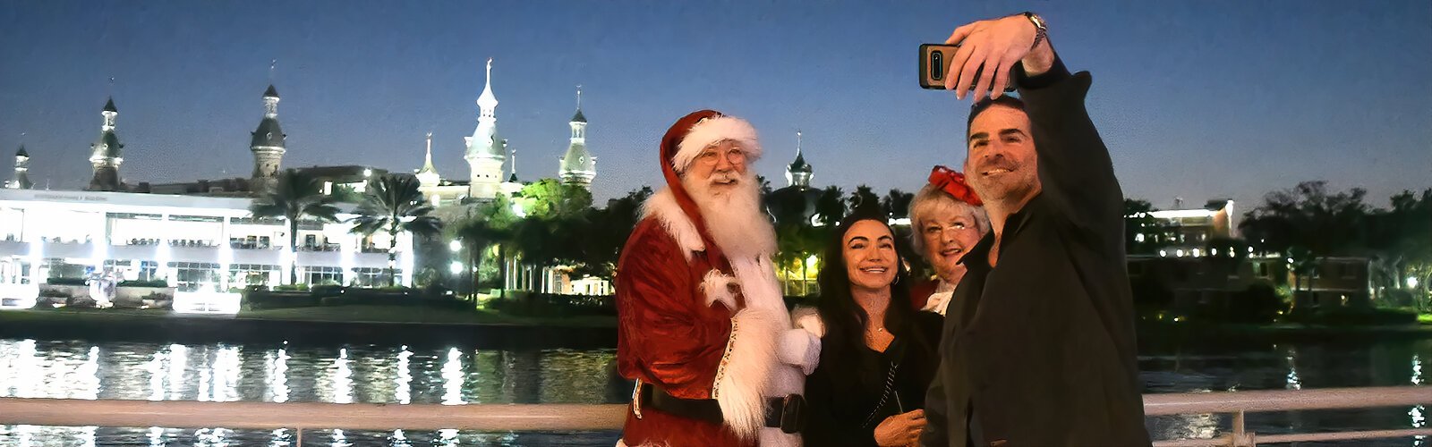 Joseph and Jennifer from Tampa seize the occasion to take a selfie with Santa and Mrs. Claus along the Riverwalk.