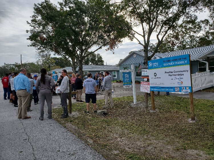 Friends, family and staff of Habitat for Humanity of Pinellas and West Pasco Counties gather to celebrate new homes for the Diviney and Al-Rubaye/Qasim families.