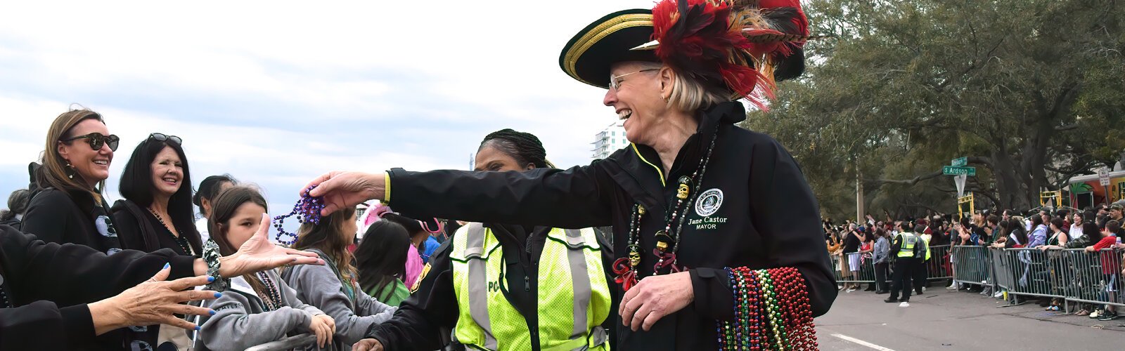 Tampa Mayor Jane Castor hands out beads during the Gasparilla parade of January 28. Earlier, she had relinquished the key of the city to Ye Mystic Krewe of Gasparilla, the invading pirates.