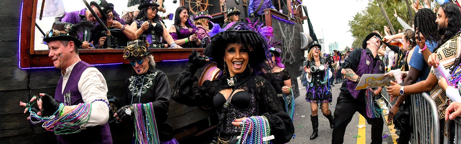 Krewe members parade along Bayshore Boulevard in Tampa on the 4.5-mile-long parade route, at times stopping for a swig of rum offered by a spectator.