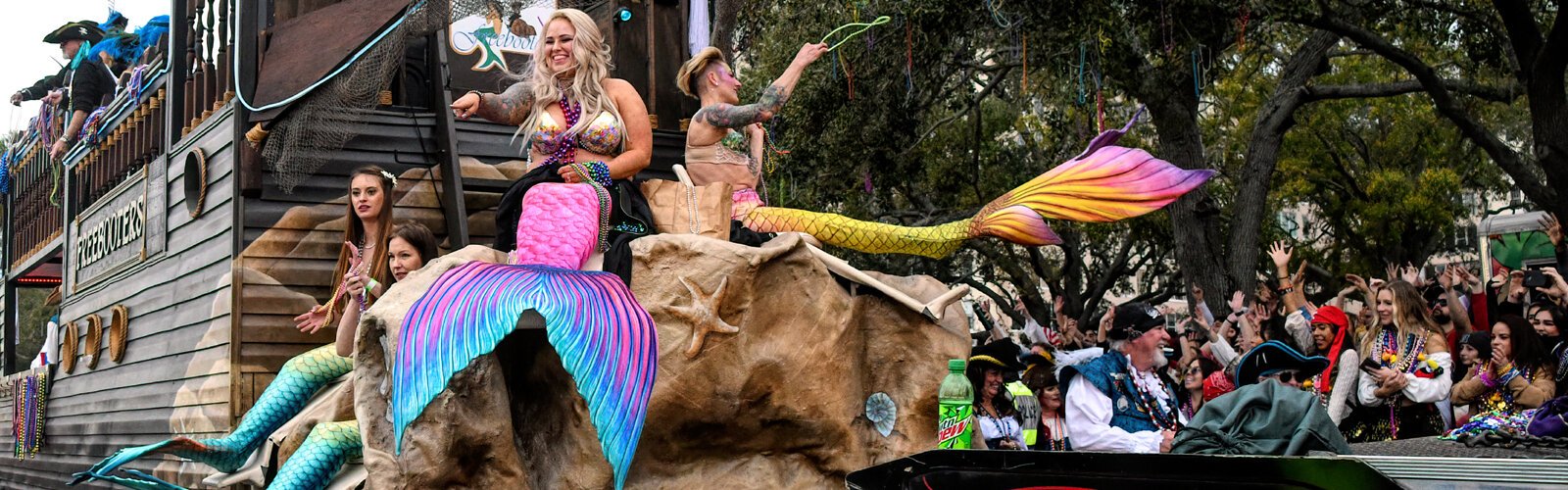 The beautiful mermaids of the Freebooters float make a splash down Bayshore Boulevard with their colorful fishtails.