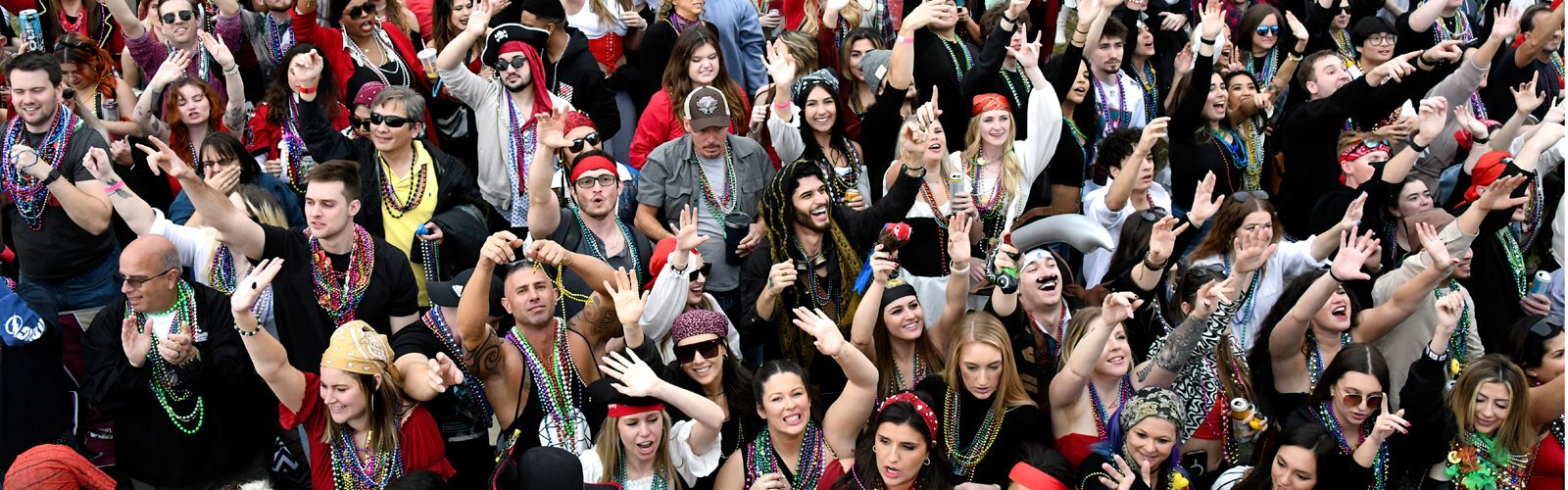 A pirate-loving crowd awaits beads from the parading floats. 