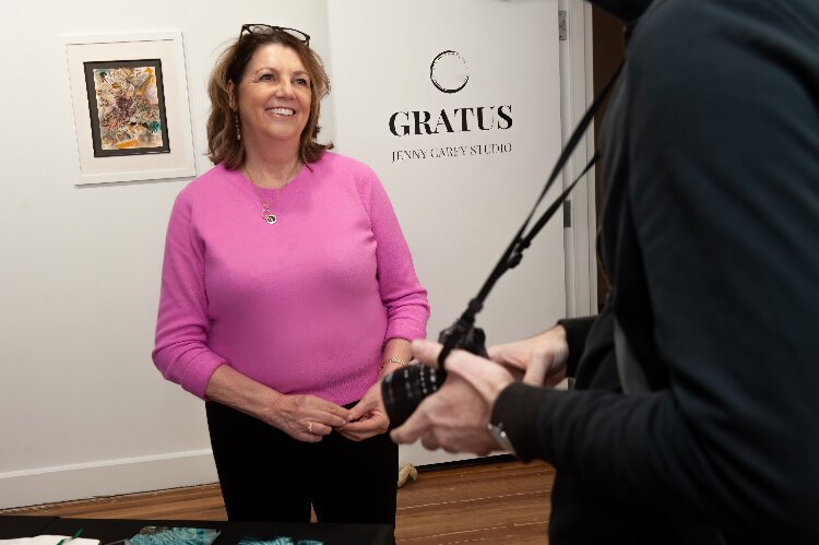 Jenny Carey chats with a photographer in her studio and gallery GRATUS during a  reception event to mark the opening of the arts hub at the Kress Building in Ybor City.