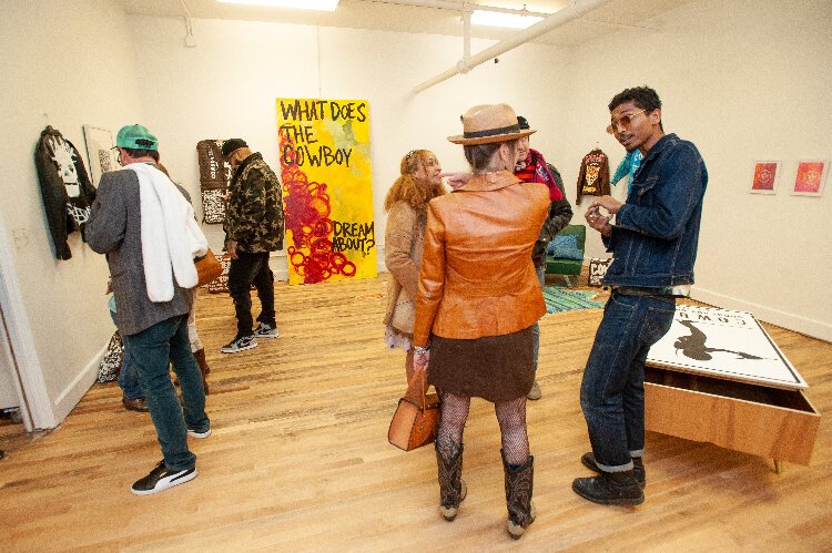 Takeo Faison shares a conversation during the opening reception for his exhibit "What Does the Cowboy Dream About?" 