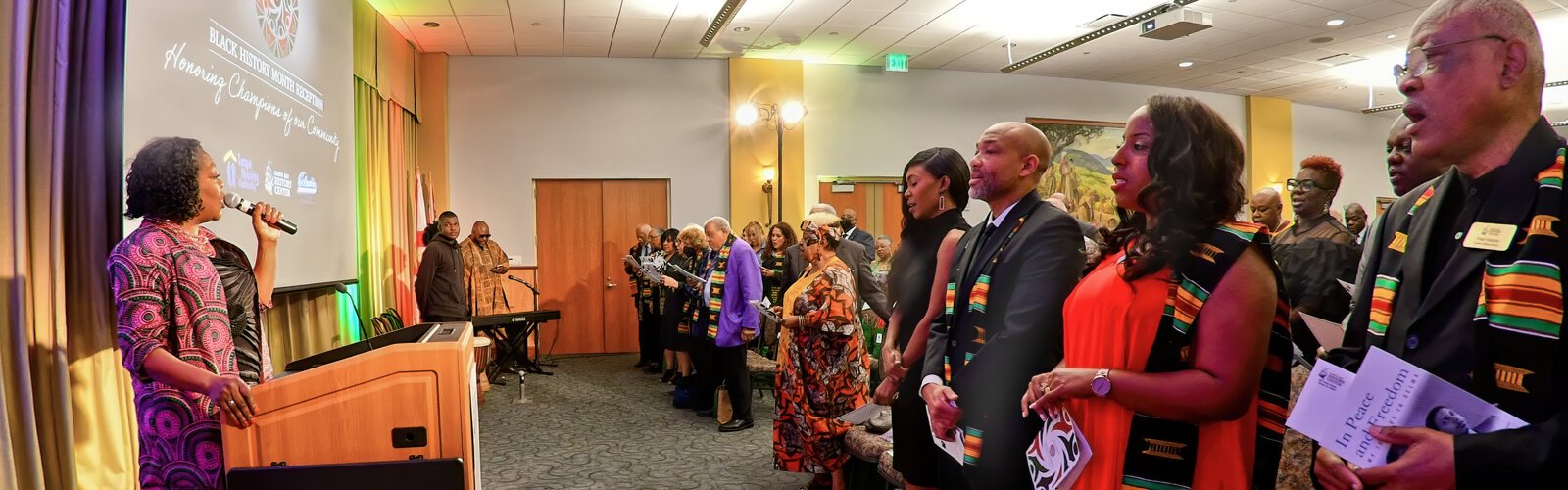 Sonja Wise and the audience sing the Black National Anthem “Lift Every Voice and Sing." 10 Tampa Bay reporter/anchor Emerald Morrow, master of ceremonies Cedric McCray, mistress of ceremonies Kari Knowles and historian Fred Hearns stand in the front