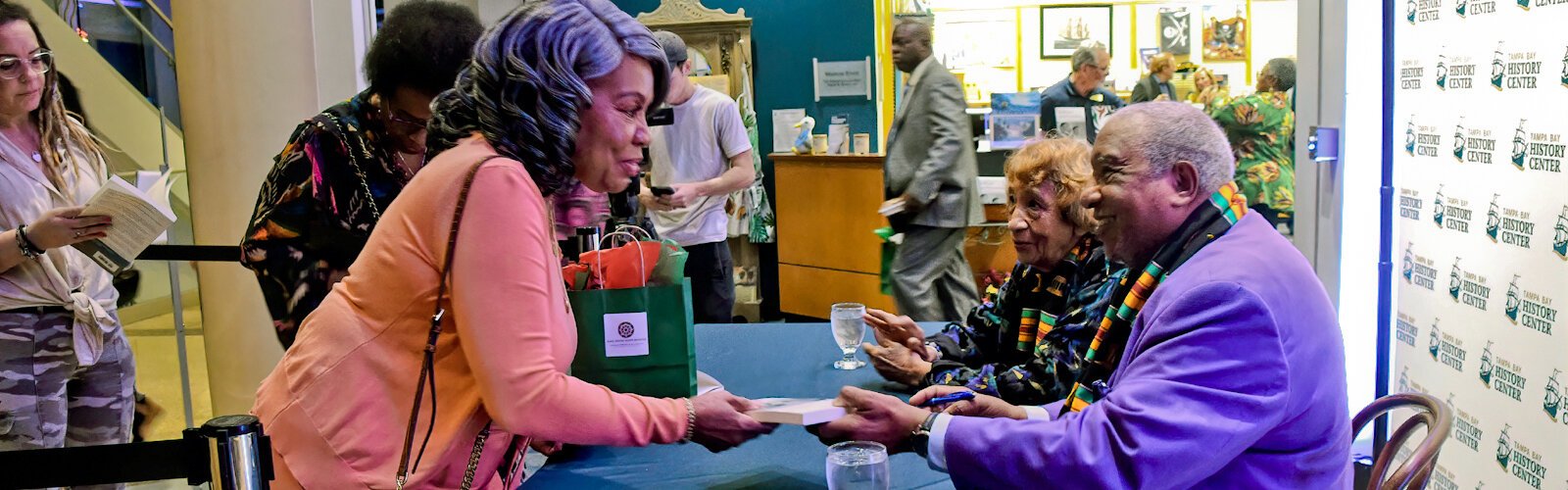 With his wife by his side, Dr. Bernard LaFayette Jr. signs his book in which he reflects on his years in Selma, Alabama, and his work with Dr. Martin Luther King Jr. and Congressman John Lewis, who was his college roommate.