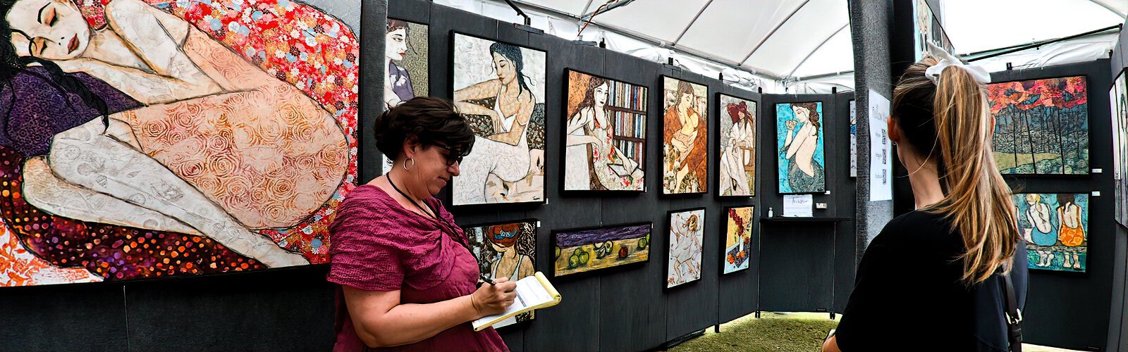 Artist Sharon Tesser writes a receipt for the sale of one of her unique textile mosaic artworks. Using fabric instead of paint, she creates fine art that tells simple stories of every day life in a delicate fashion.