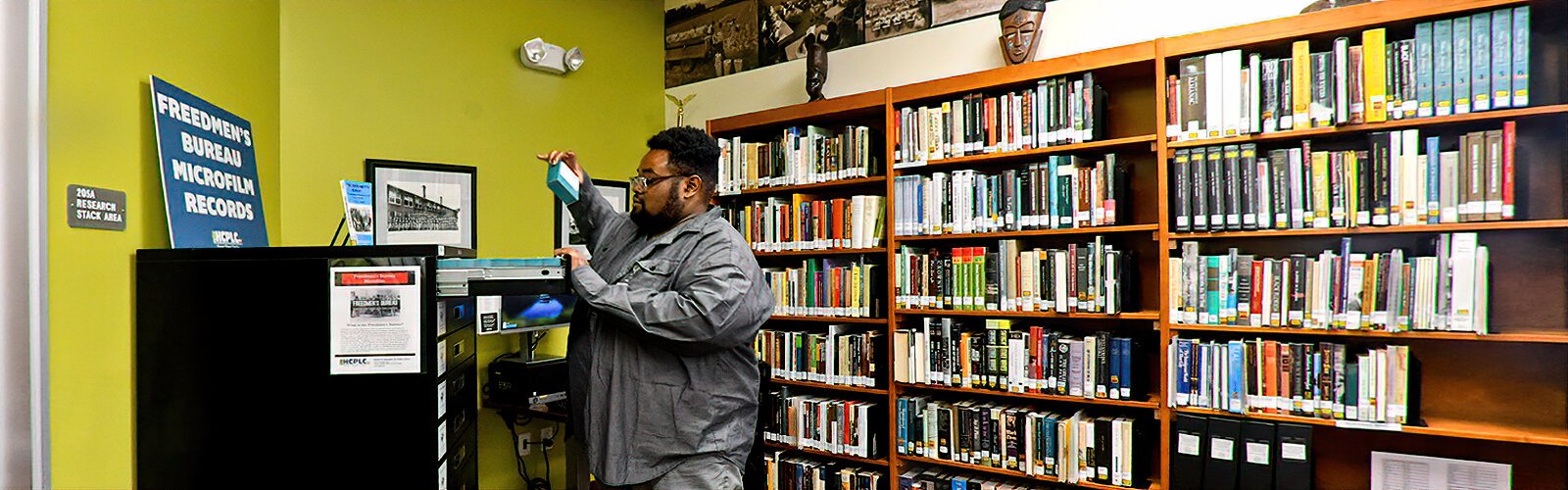  Supervisory Librarian Shedriek Battle picks out a microfilm from the Freedmen’s Bureau microfilm records at the Robert W. Saunders, Sr. Public Library. The library has the largest genealogy collection in the Southeast.