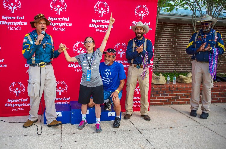 Pinellas Park Power Peddlers' Amanda Newman celebrates with the Tampa Rough Riders after winning one of several ribbons during the  ​Special Olympics Hillsborough-Pinellas County Summer Games.