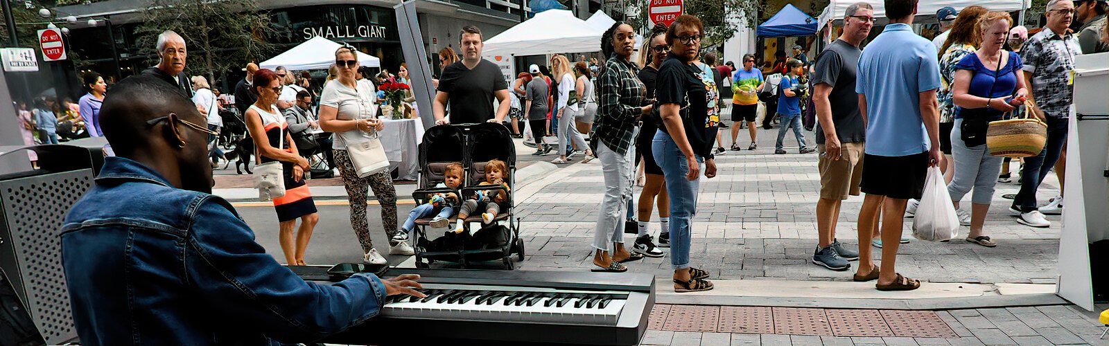 Musician Caleb Lattimore provides live music on piano during The Market at Water Street Tampa.