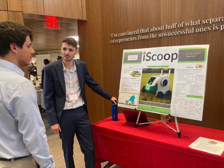 University of Tampa graduate student Lucas Scordo pitches his product, the iSCoop, during the 2023 New Venture Expo at the John P. Lowth Entrepreneurship Center