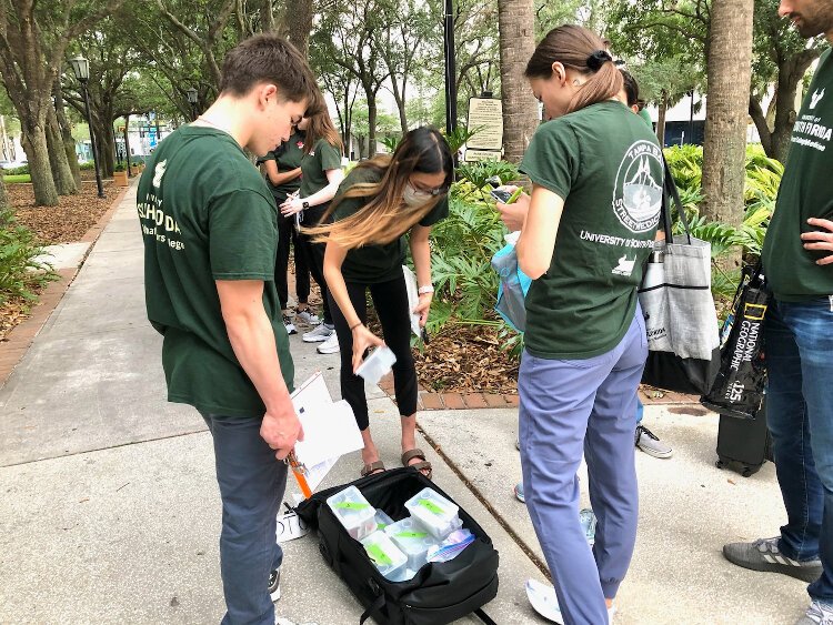 USF Health Morsani College of Medicine students Oslow Odegaard, Jennifer Zhou and Allison O. Dumitriu Carcoana inspect hygiene and medical supplies they offer homeless persons in need as part of the Tampa Bay Street Medicine program.