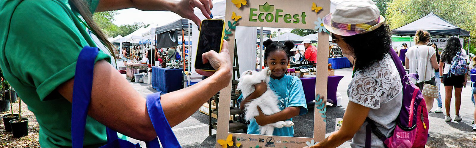 Volunteers use a frame to take a picture of a young girl with a pet rabbit at the 13th annual EcoFest, which celebrated Earth Day on April 22nd at the Museum of Science and Industry (MOSI) in Tampa.