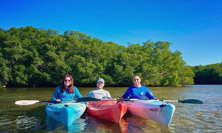 Ellie Foden, director of conservation and kayak instructor for ECOmersion; company co-founder Noah Shaffer; and Brady Goldstein, special programs coordinator and tour guide.