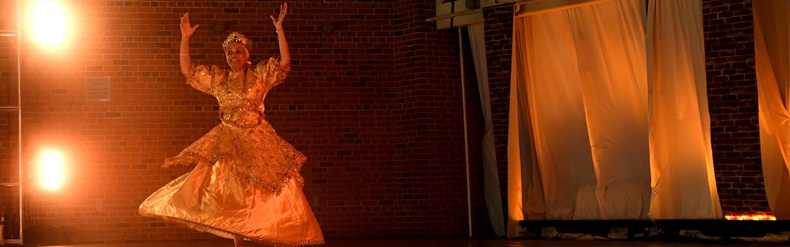 Choreographer Milagros Ramirez performs “Wemilere a Oshun," an African Cuban dance where Oshun represents beauty, the river goddess, honey and gold.