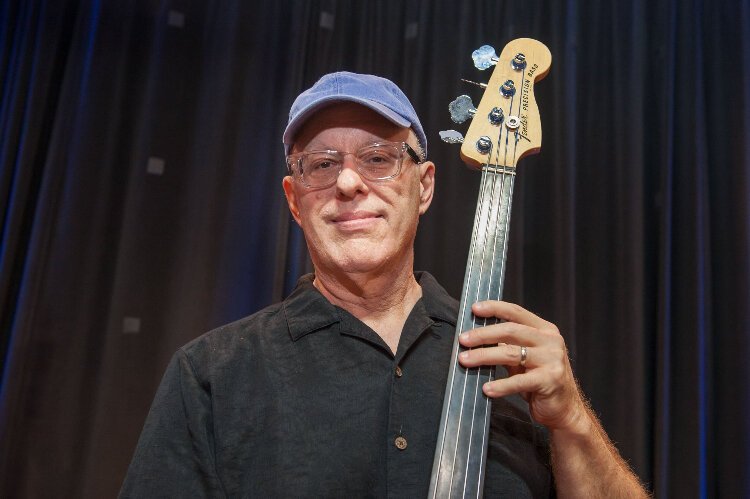 Philip Booth has played bass guitar in several bands. Today, he plays bass fiddle in Acme Jazz Garage and, after a four-decade break, picked up the French horn again, playing with Fanfare Concert Winds.