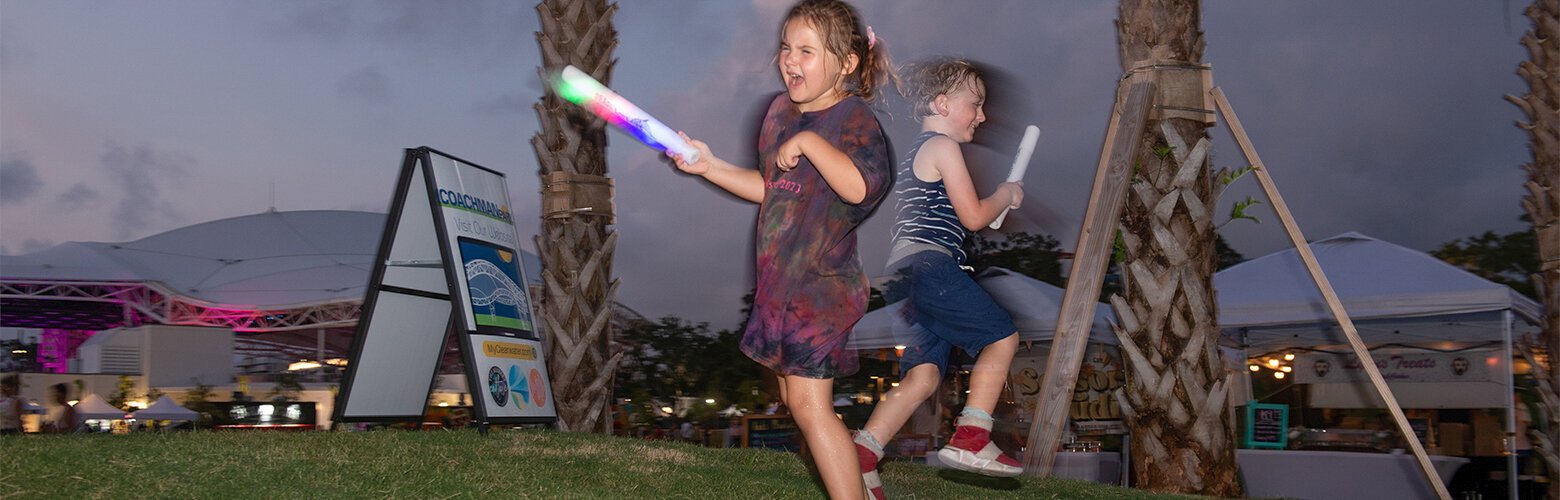 Emma Danielson, 5, and River Desi, 5, from Tampa, play in the vendor area during the Coachman Park grand opening.