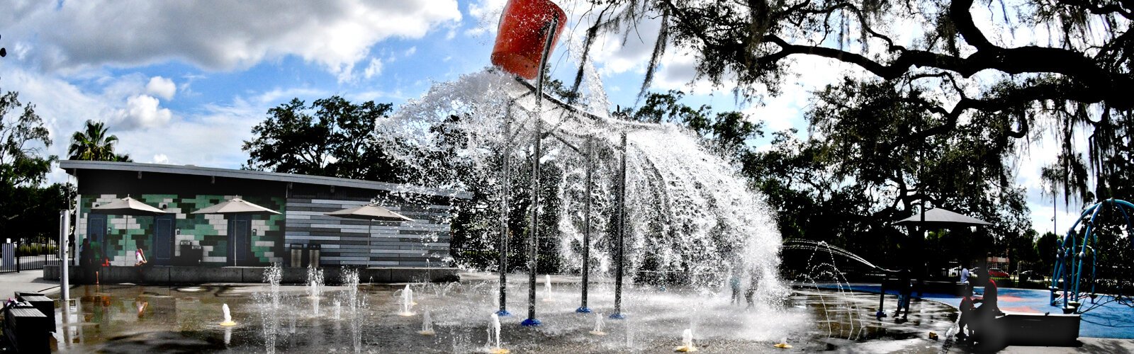 A large bucket splashing gallons of water on the splash pad every few minutes is a cool way to cool off from the sweltering heat at Julian B. Lane Riverfront Park in Tampa's West River area.