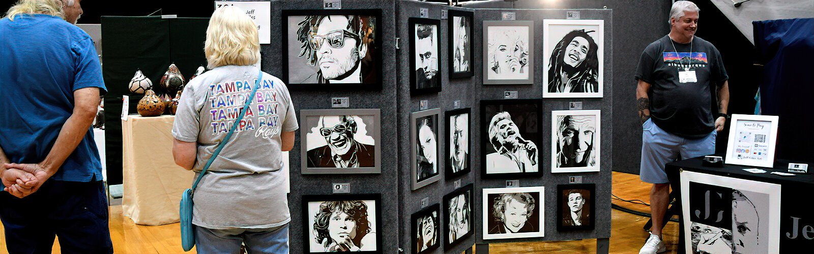  Black-and-white pen and ink drawings of famous personalities by St. Petersburg portrait artist Jeff Giles catch the eye of visitors as they wander through  PAVA’s Cool Art Show.