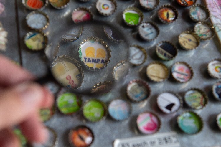 ReUsin' By Susan reuses old bottle caps and maps to make accessories.
