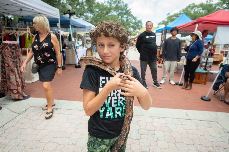Seth Lieberman, 9, from Tampa, walked around the Ybor City Saturday Market with the family snake.