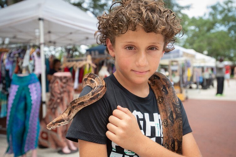Seth Lieberman, 9, from Tampa, walked around the Ybor City Saturday Market with the family snake.
