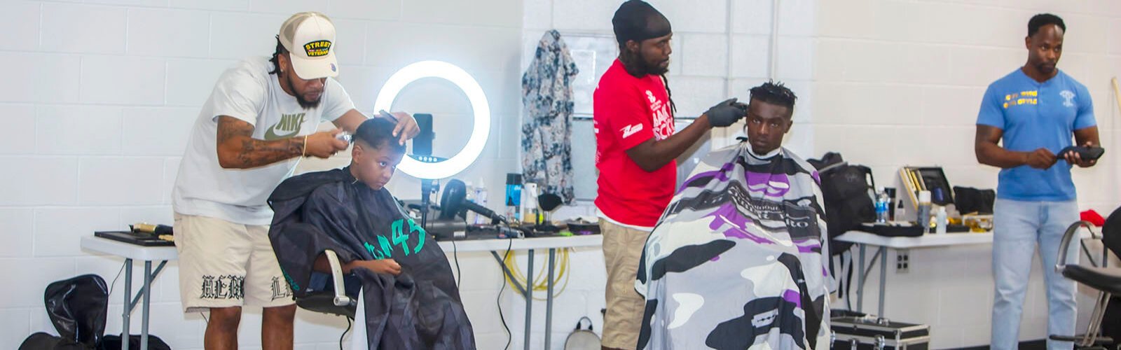 Hair stylists and barbers donated their services for hundreds of children and teens in a pop-up salon at the Bullard Family Foundation's 6th Annual Back to School Bash, organized by WWE superstar Titus O'Neil/Thaddeus Bullard at Raymond James Stadium