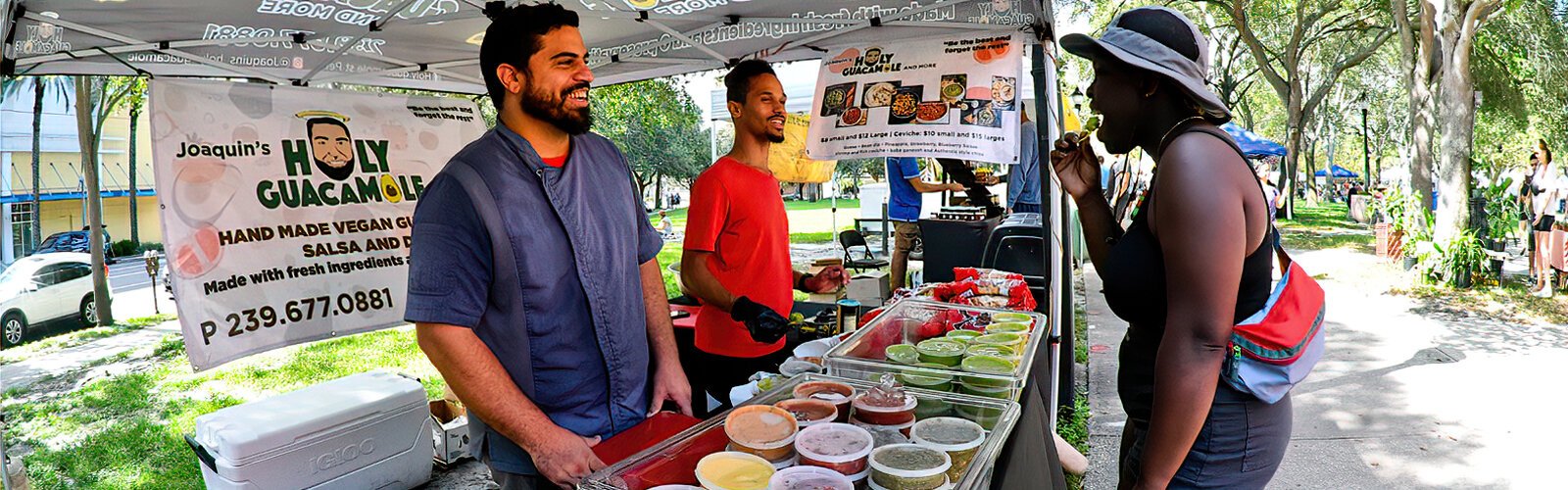 Joaquin Anaya of Joaquin’s Holy Guacamole is all smiles as a customer samples his vegan green dip handmade with fresh ingredients and no preservatives.