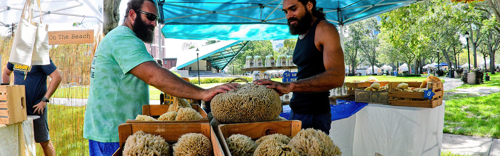 Sponge diver Zach of Tropical Sea Sponges in Tarpon Springs educates a curious shopper about the marine sponges he harvests himself and then sells at markets with other related products.