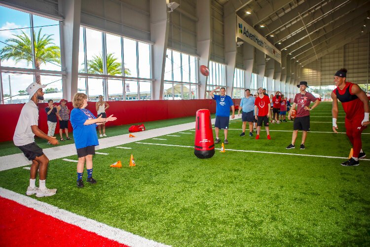 As part of the Tampa Bay Buccaneers' annual Community Impact Day, the team and players like outside linebacker Joe Tryon-Shoyinka welcomed Special Olympics Florida athletes and guests from various nonprofit groups to training cam​p.