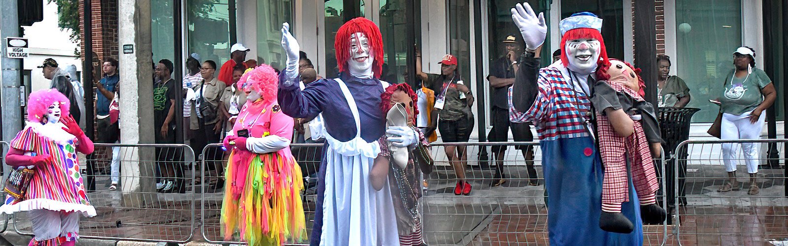 Clowns Raggedy Ann and Andy wave to the crowd as they entertain parade watchers along their route in Ybor City.