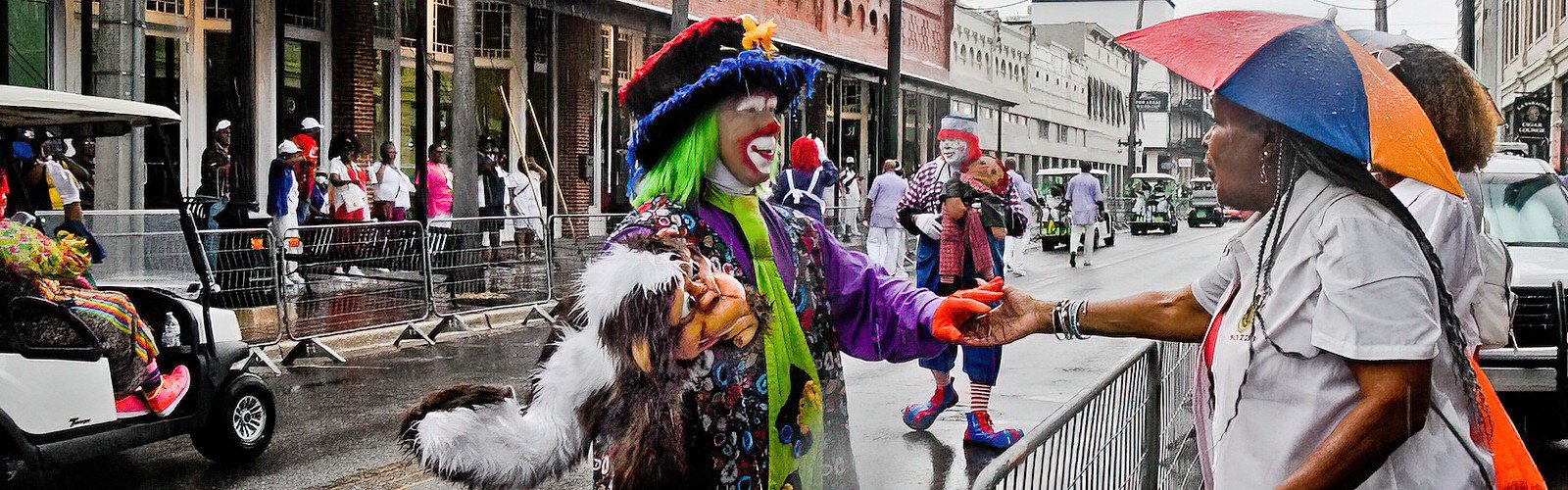 A smiling clown interacts with a parade watcher. The AEAONMS Inc. is recognized as a benevolent, charitable and fraternal organization supporting many development programs in the civic, economic, medical and educational fields.