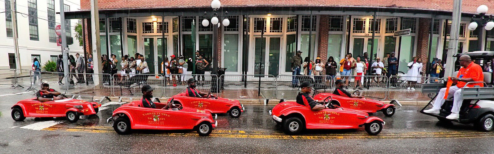 Members of the motor unit of the Nabbar Temple No. 128 from Atlanta, GA have fun with their tiny red cars, a particularity that distinguishes them as Shriners.