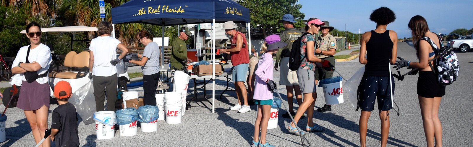 Volunteers get supplies to pick up trash off the beach during International Coastal Cleanup Day  at Honeymoon Island State Park in Dunedin on September 16th.