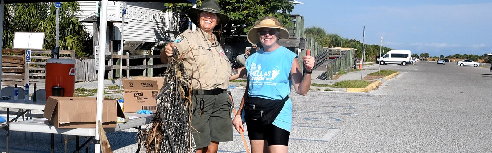 Park services specialist Beth Reynolds congratulates Barbara Piltaver, an Illinois native living part-time in Dunedin, for being the first volunteer to return from the beach with large pieces of debris