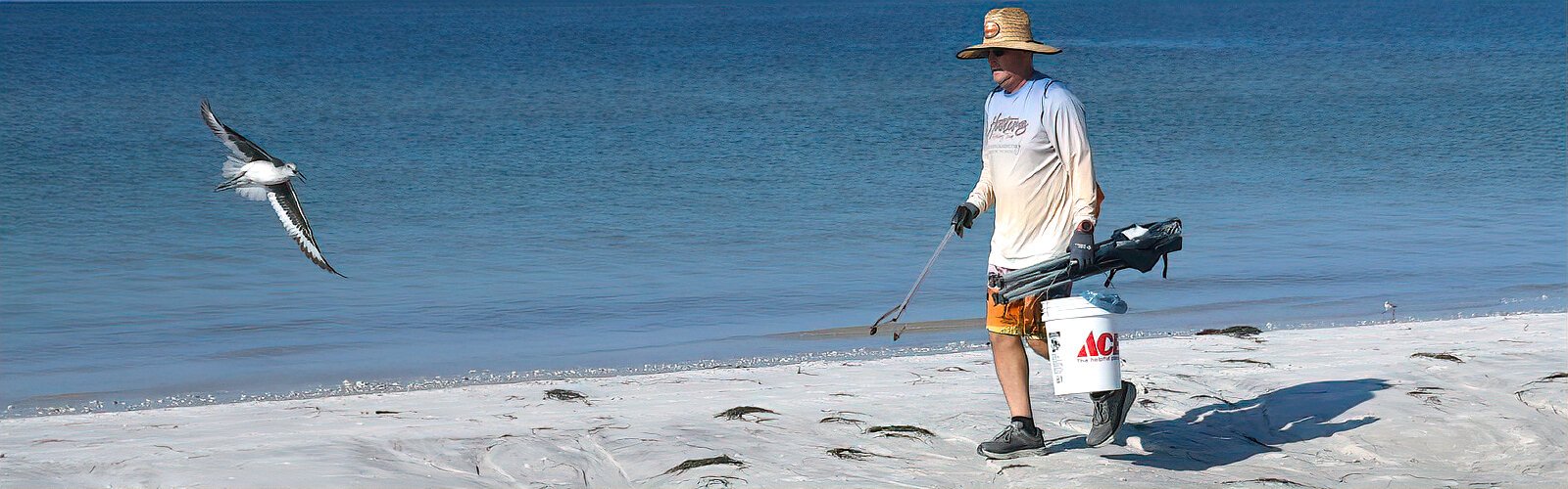 A volunteer returns with a damaged folding chair discarded on the beach at Honeymoon Island State Park. The growing pollution problem on beaches around the world is what started the International Coastal Cleanup some 35 years ago.