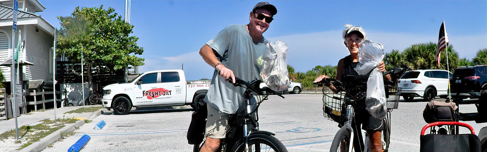 Bicyclists Bob and Kerry Higginbotham, from Clearwater, get back to the Florida State Parks booth with trash they picked up during their bicycle ride.