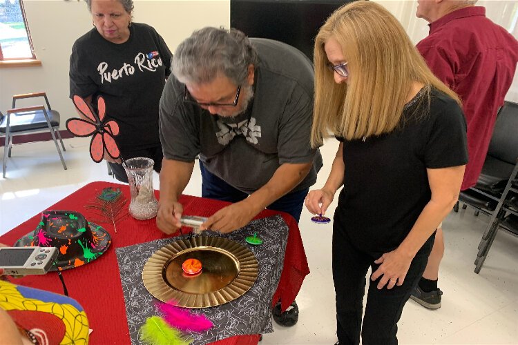 Instructor Cathy Dutertre works with a student in a photography class the Hillsborough County Department of Aging Services offers in conjunction with the Florida Museum of Photographic Arts.