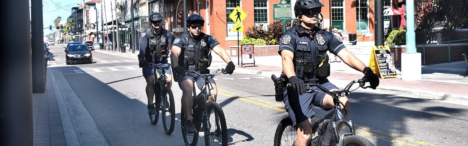 Following World Car-Free Day guidelines, three police officers patrol on bicycle down Seventh Avenue in Ybor City on the morning of Saturday, September 23rd.