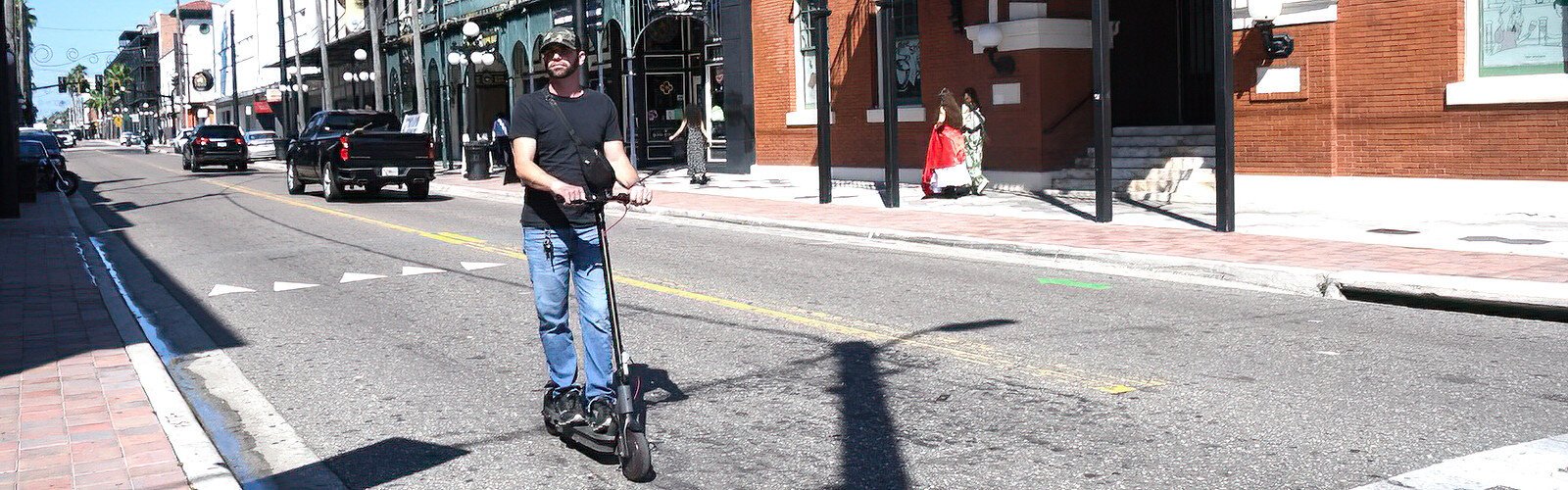 A lone rider on an e-scooter rolls along Seventh Avenue in Ybor City, taking advantage of the sparse traffic during World Car-Free Day. 