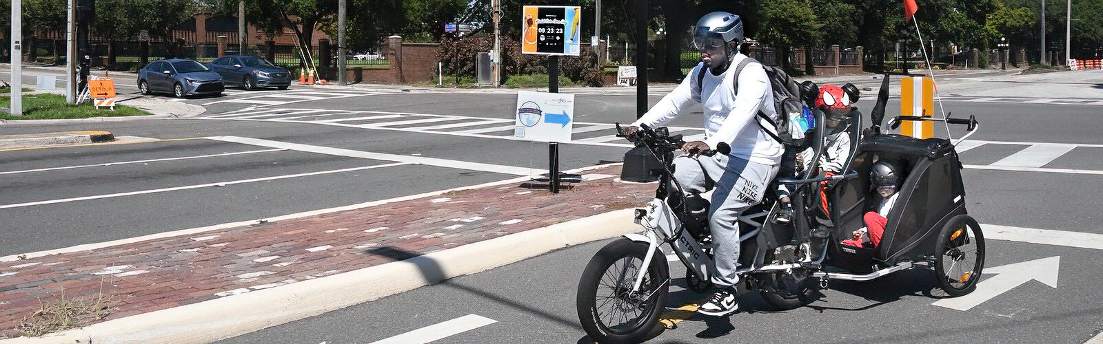 World Car-Free Day is a family affair for this dad hauling his three children on an e-bike. Mom was in front on another e-bike.