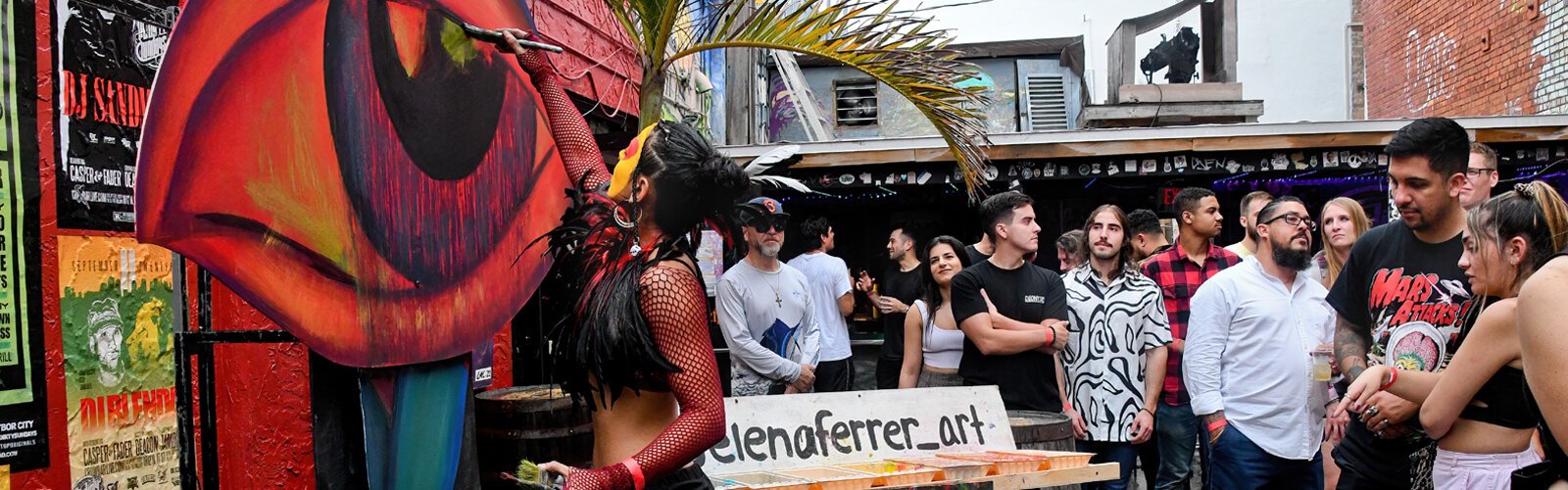 Live painter and performance artist Selena Ferrer works on a surrealist two-piece artwork to be later auctioned off online.