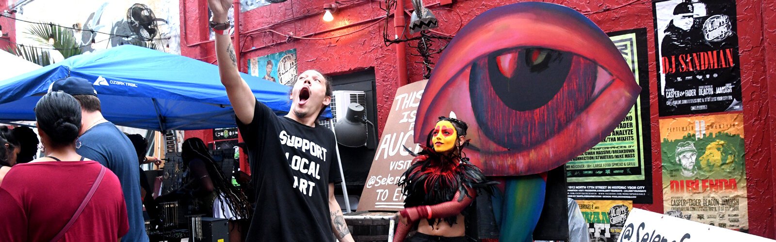 Poet, educator and performance artist Dennis Amadeus takes a selfie with artist Selena Ferrer in front of her artwork still in progress.