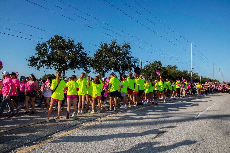 Volunteer cheerleaders at the American Cancer Society's Making Strides Against Breast Cancer Walk at Raymond James Stadium encourage the estimated 25,000 attendees at the annual event.